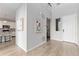 Inviting entryway showcasing an open floor plan, wood floors, and tasteful wall decor at 18815 W 93Rd Ave, Arvada, CO 80007