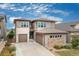 Charming two-story home with a two-car garage and well-manicured landscaping that enhances its curb appeal at 18815 W 93Rd Ave, Arvada, CO 80007