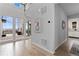 Bright hallway leads to an outdoor patio, featuring neutral walls and stylish decor at 18815 W 93Rd Ave, Arvada, CO 80007