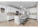 Modern kitchen with white cabinets, granite countertops, and stainless steel appliances at 18815 W 93Rd Ave, Arvada, CO 80007