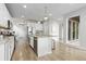 Bright kitchen features a large island with granite countertops and stainless steel appliances at 18815 W 93Rd Ave, Arvada, CO 80007