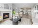 Open-concept living space with cozy fireplace and seamless access to the kitchen and dining areas at 18815 W 93Rd Ave, Arvada, CO 80007