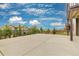 Spacious concrete patio overlooking a neighborhood with well-maintained lawns and beautiful sky at 18815 W 93Rd Ave, Arvada, CO 80007