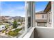 Bright view from window showcases charming neighborhood homes and sunny blue skies at 18815 W 93Rd Ave, Arvada, CO 80007