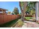 Spacious backyard with a stone patio and wooden fence at 1275 Birch St, Denver, CO 80220