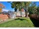 View of the backyard highlighting the green grass and shade trees, enhancing the home's outdoor appeal at 1275 Birch St, Denver, CO 80220