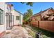 Stone patio leads to an open gate and lush backyard, perfect for outdoor entertaining at 1275 Birch St, Denver, CO 80220