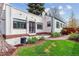 Charming backyard with a patio, lush lawn, and garden beds at 1275 Birch St, Denver, CO 80220