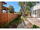 Expansive backyard featuring a well-maintained lawn, brick patio, bordered by a sturdy wooden fence for added privacy at 1275 Birch St, Denver, CO 80220