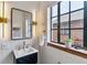 Stylish bathroom with a modern mirror, designer lighting, and a decorative sink at 1275 Birch St, Denver, CO 80220
