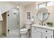 Bright bathroom with a glass shower, modern vanity, and a neutral color palette at 1275 Birch St, Denver, CO 80220