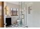 Updated bathroom with a glass-enclosed shower, black and white tile, and modern fixtures at 1275 Birch St, Denver, CO 80220