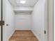 Walk-in closet with hardwood floors, white paint, and single light fixture at 1275 Birch St, Denver, CO 80220