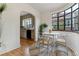 Stylish dining area with hardwood floors and a view into the adjacent kitchen area at 1275 Birch St, Denver, CO 80220