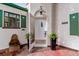 Charming front entrance with a white door, brick accents, and decorative plants at 1275 Birch St, Denver, CO 80220