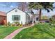Attractive home exterior with well-manicured lawn and vibrant green shutters at 1275 Birch St, Denver, CO 80220