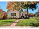 Charming home with a lush front yard, brick walkway with fall foliage at 1275 Birch St, Denver, CO 80220