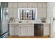 Bright kitchen with white cabinets, marble countertops, and modern stainless steel appliances at 1275 Birch St, Denver, CO 80220