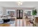 Inviting living room with hardwood floors, white walls, modern lighting, and stylish furniture at 1275 Birch St, Denver, CO 80220