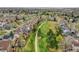 A stunning aerial shot captures a neighborhood with lush green spaces and a winding pathway, framed by beautiful homes at 6343 Laguna Cir, Highlands Ranch, CO 80130