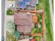 Aerial view of a home with a backyard deck and lush landscaping, bordered by a wooden fence and colorful ground cover at 6343 Laguna Cir, Highlands Ranch, CO 80130