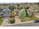 A high-definition aerial view showcases a well-manicured front yard with a large tree and a perfectly paved driveway at 6343 Laguna Cir, Highlands Ranch, CO 80130