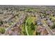 Wide aerial view showcasing the neighborhood's layout with houses backing onto a green space, creating a sense of community at 6343 Laguna Cir, Highlands Ranch, CO 80130