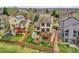 This is an aerial view of the house's fenced backyard, complete with a deck, green grass, and a young blossoming tree at 6343 Laguna Cir, Highlands Ranch, CO 80130