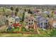 This aerial view of the property displays a fenced yard, a cozy deck, and lush greenery surrounded by neighboring homes at 6343 Laguna Cir, Highlands Ranch, CO 80130