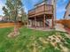 Backyard featuring a deck, lush grass, and partial fencing for privacy at 6343 Laguna Cir, Highlands Ranch, CO 80130