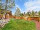 Large backyard with a wooden fence, a deck, and a grassy area at 6343 Laguna Cir, Highlands Ranch, CO 80130