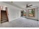 Finished basement with carpet, a sliding door to the backyard, and a stairwell to the main floor at 6343 Laguna Cir, Highlands Ranch, CO 80130