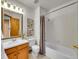 Bathroom featuring neutral tile, a vanity, a toilet, and a shower/tub combination at 6343 Laguna Cir, Highlands Ranch, CO 80130