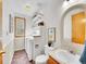 A bathroom featuring a sink, toilet, and laundry with a window, shelves, and decorations at 6343 Laguna Cir, Highlands Ranch, CO 80130