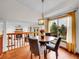 Inviting dining area with hardwood floors, modern lighting, and a large picture window at 6343 Laguna Cir, Highlands Ranch, CO 80130