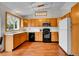 Functional kitchen with wooden cabinets, black appliances, and ample counter space at 6343 Laguna Cir, Highlands Ranch, CO 80130