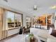 Comfortable living room with a large window, ceiling fan, and seamless flow to other living areas at 6343 Laguna Cir, Highlands Ranch, CO 80130