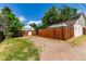 Spacious backyard with a wooden fence and a mix of grass and gravel areas, great for outdoor activities at 4450 S Fox St, Englewood, CO 80110