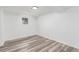 Basement with vinyl floors, neutral walls, bright overhead lighting, and a small window at 4450 S Fox St, Englewood, CO 80110