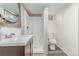 Renovated bathroom boasts modern vanity, stylish shower, and wood accent wall feature at 4450 S Fox St, Englewood, CO 80110