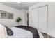 Bedroom with neutral walls and flooring, stylish decor, and a large closet with sliding doors at 4450 S Fox St, Englewood, CO 80110