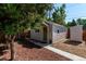 Charming exterior of a home featuring wood siding, a welcoming front door, and professional landscaping at 4450 S Fox St, Englewood, CO 80110
