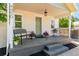 Inviting front porch with bench seating and decorative plants, perfect for enjoying the outdoors at 4450 S Fox St, Englewood, CO 80110