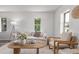 Bright living room with modern decor, neutral color palette, and large windows for natural light at 4450 S Fox St, Englewood, CO 80110