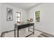 Inviting office space with natural light, a modern desk, and a comfortable chair on an area rug at 4450 S Fox St, Englewood, CO 80110