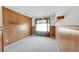 Cozy bedroom with neutral carpeting features wood paneling and a large window at 1283 W 112Th Ave # B, Denver, CO 80234