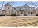 Exterior shot of townhomes with brick accents and well-maintained lawn at 1283 W 112Th Ave # B, Denver, CO 80234