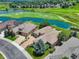 Aerial view of home on golf course, beautiful landscaping, water features, and serene neighborhood at 11208 W Ontario Ave, Littleton, CO 80127