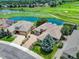 Aerial view of beautiful homes with well-maintained landscaping, set against a backdrop of a golf course and water feature at 11208 W Ontario Ave, Littleton, CO 80127