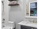 Bathroom featuring a modern vanity, soaking tub, tiled walls and floating shelves at 11208 W Ontario Ave, Littleton, CO 80127
